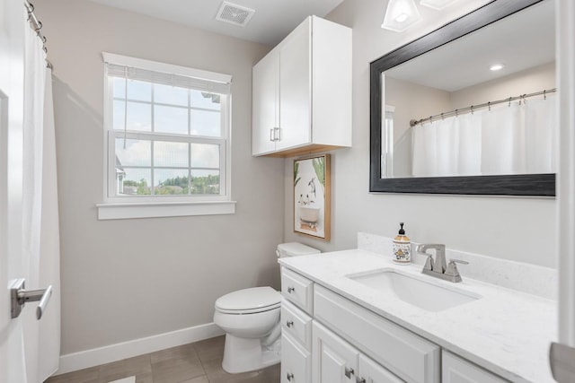 bathroom with visible vents, baseboards, tile patterned floors, vanity, and toilet