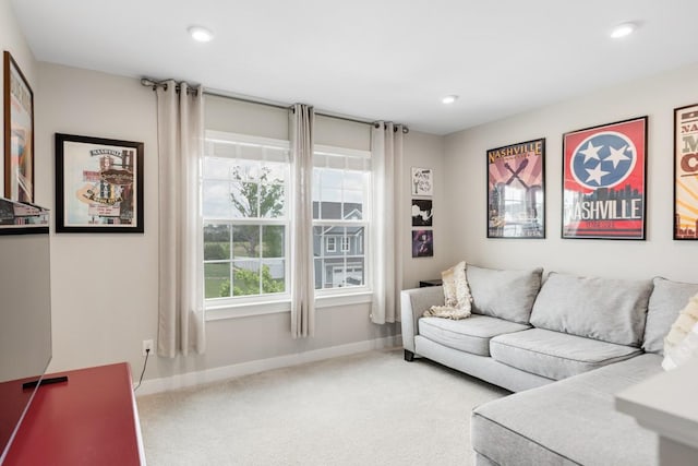 carpeted living area featuring recessed lighting and baseboards
