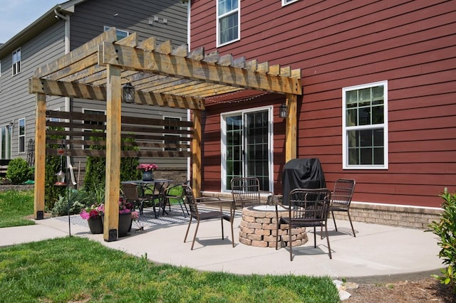 view of patio with area for grilling, a pergola, and an outdoor fire pit