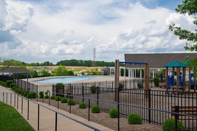 exterior space with a community pool and fence