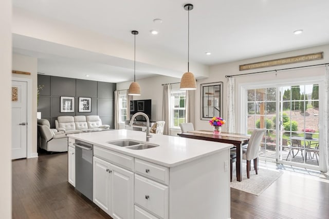 kitchen with white cabinets, a sink, dishwasher, open floor plan, and dark wood-style floors