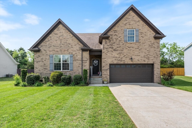 206 Hart Ln, Lebanon, TN 37087 - view of front of house with a garage, driveway, a front lawn, and brick siding