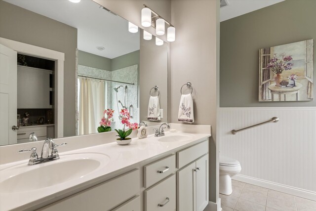 206 Hart Ln, Lebanon, TN 37087 - bathroom featuring tile patterned flooring, a sink, wainscoting, and toilet