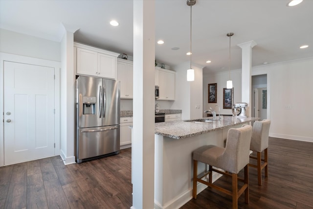 206 Hart Ln, Lebanon, TN 37087 - kitchen featuring a breakfast bar area, dark wood-style flooring, a sink, stainless steel appliances, and white cabinetry