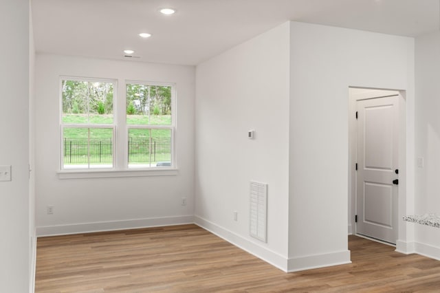unfurnished room with recessed lighting, baseboards, light wood-type flooring, and visible vents