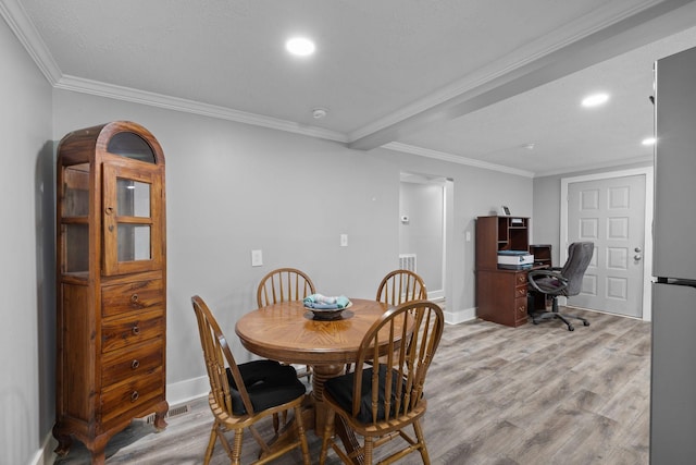 dining room featuring recessed lighting, crown molding, and light wood finished floors