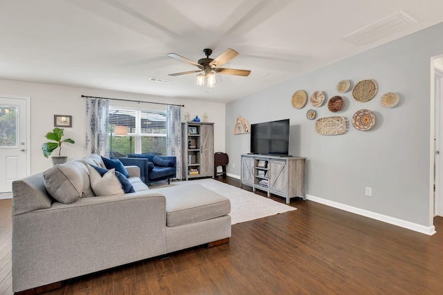 living area with a ceiling fan, visible vents, and a wealth of natural light