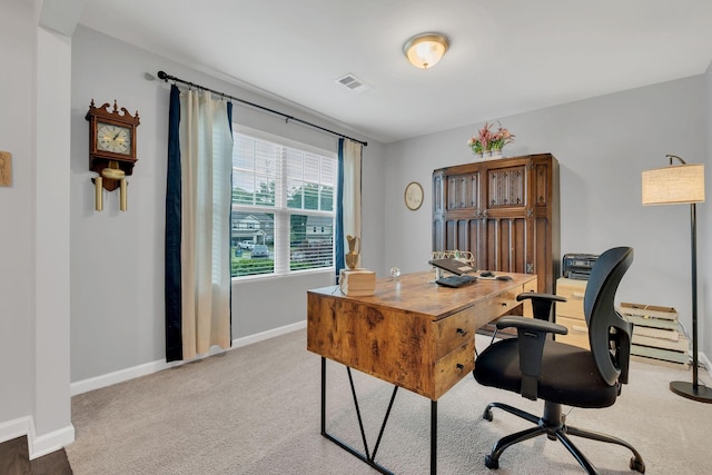 carpeted office space with baseboards and visible vents