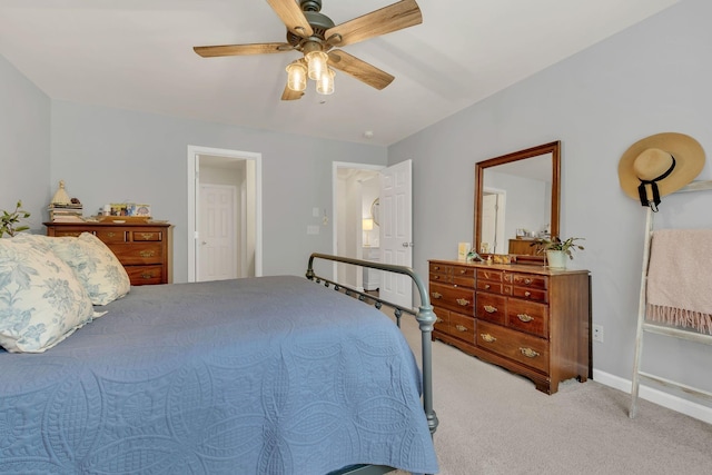 bedroom with light colored carpet, a ceiling fan, and baseboards