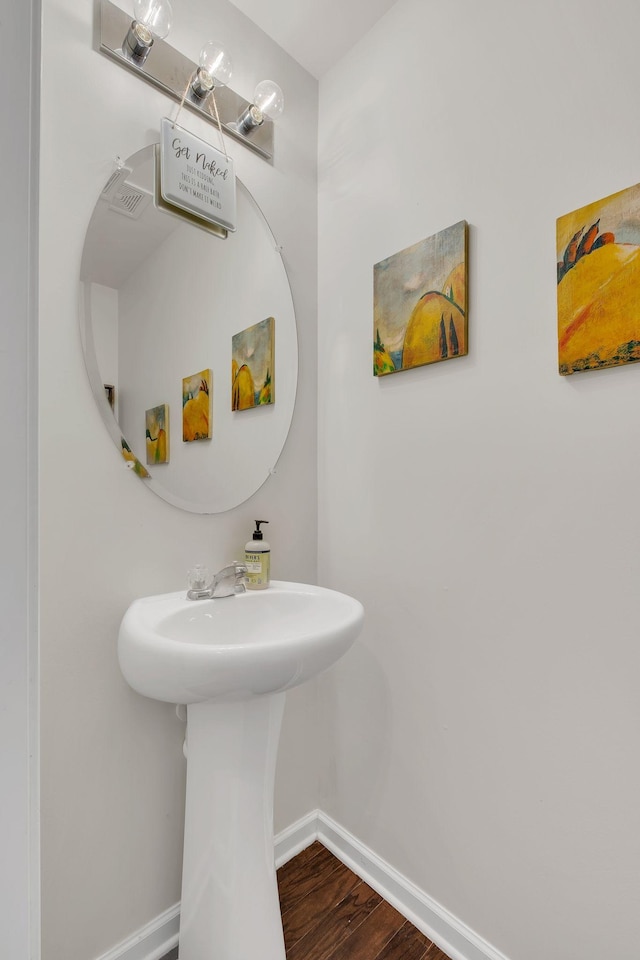 bathroom featuring baseboards and wood finished floors