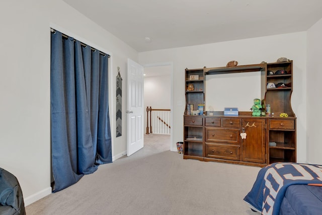 carpeted bedroom featuring baseboards