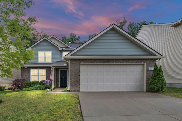 traditional-style home with an attached garage, a front yard, driveway, and brick siding