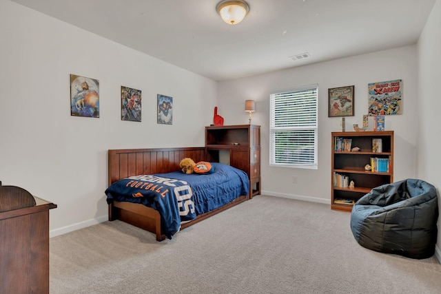 carpeted bedroom featuring baseboards and visible vents