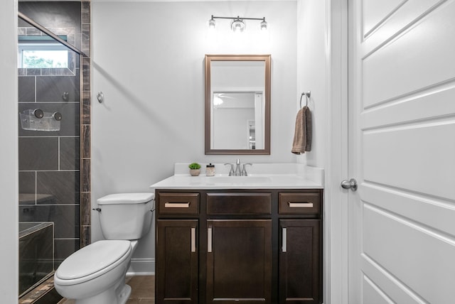 532 Herman Dr, Clarksville, TN 37042 - bathroom featuring vanity, baseboards, toilet, a tile shower, and tile patterned flooring