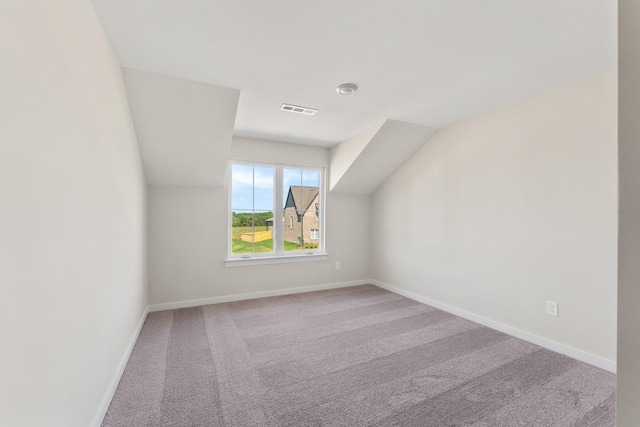 additional living space with visible vents, baseboards, and carpet floors