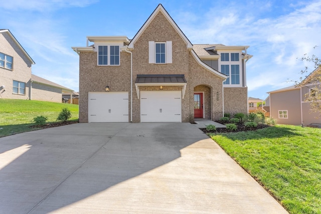 view of front facade featuring an attached garage, a front yard, brick siding, and concrete driveway