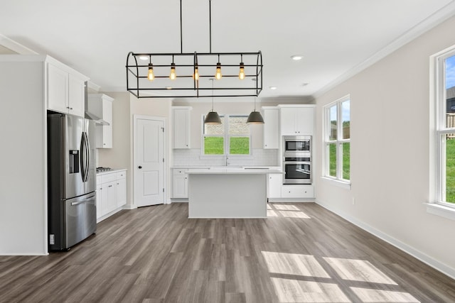 kitchen with light countertops, stainless steel appliances, and a wealth of natural light