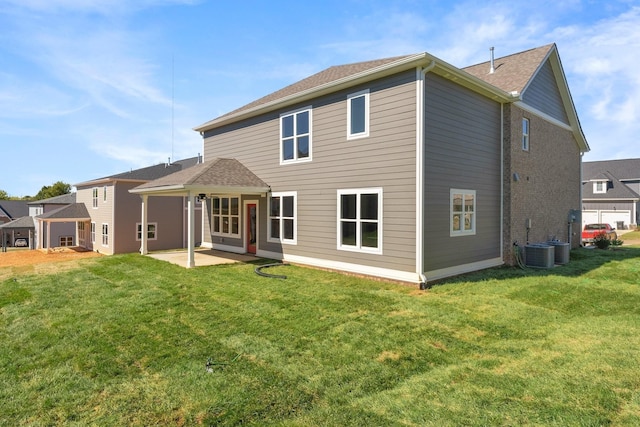 rear view of house featuring a patio and a lawn