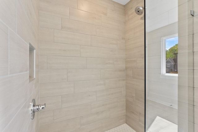 full bath with a tile shower