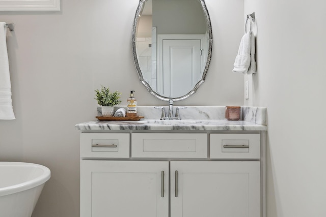 bathroom featuring a freestanding tub and vanity