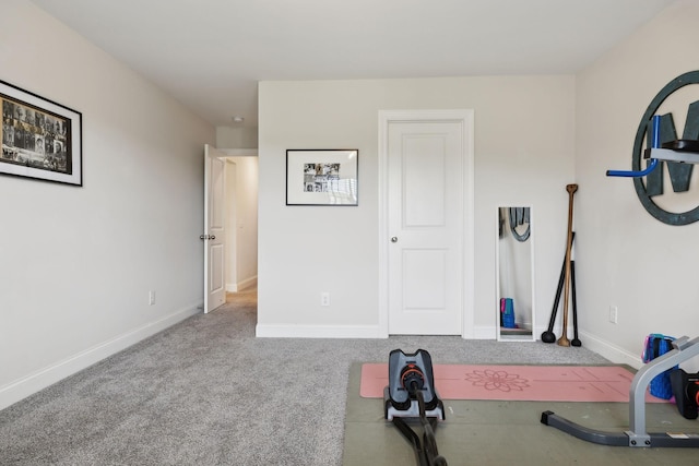workout room with baseboards and carpet flooring