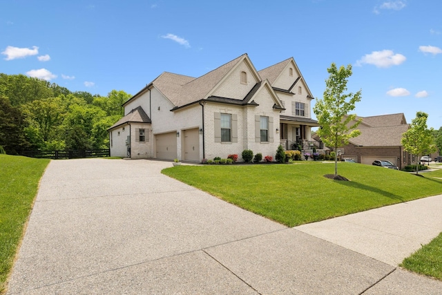 view of front of home with a garage, a front lawn, fence, brick siding, and driveway