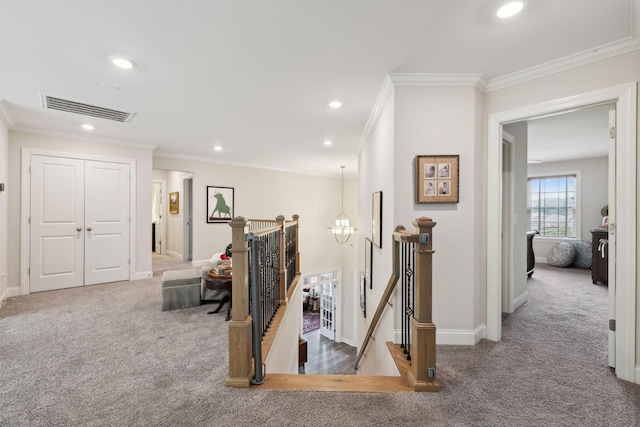 hallway with carpet flooring, recessed lighting, an upstairs landing, visible vents, and ornamental molding