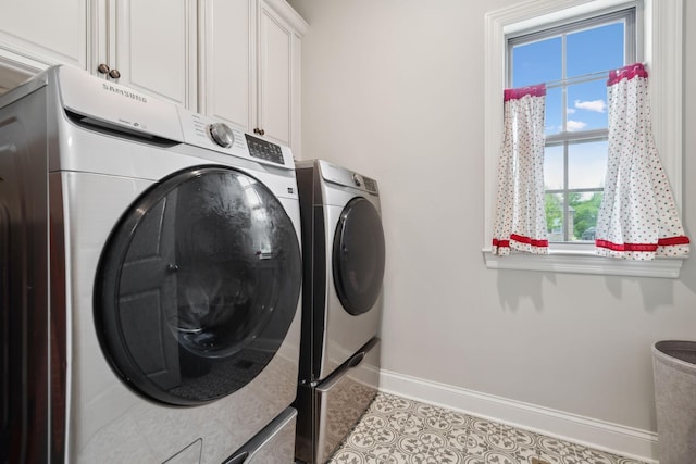laundry room with baseboards, separate washer and dryer, tile patterned floors, and cabinet space