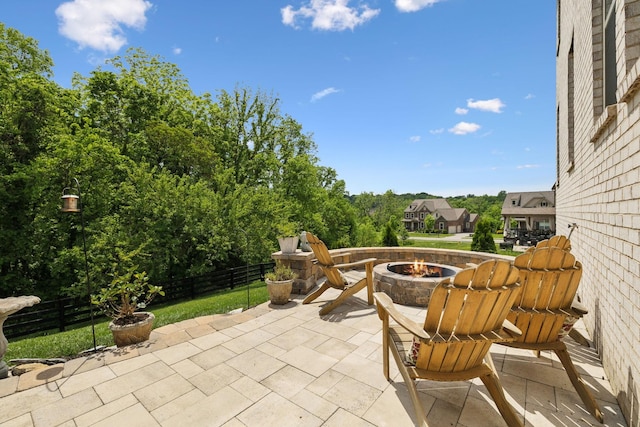 view of patio / terrace with fence and a fire pit
