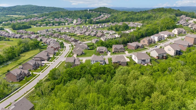 bird's eye view featuring a forest view and a residential view