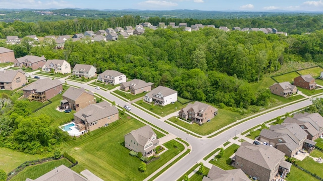 drone / aerial view with a residential view and a view of trees