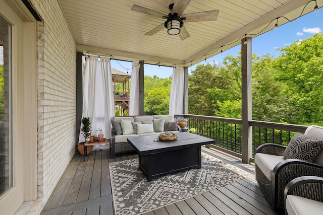 sunroom / solarium with ceiling fan and an outdoor living space