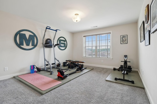 exercise room featuring carpet floors, baseboards, and visible vents