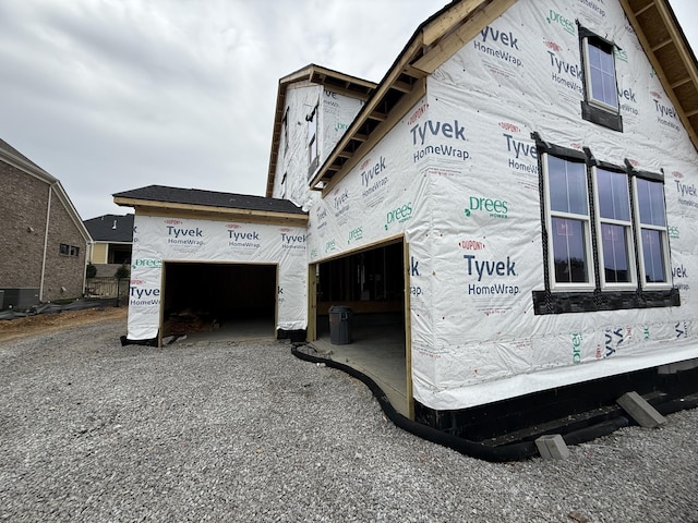 view of home's exterior featuring a garage and cooling unit