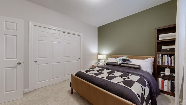 bedroom featuring a closet and light carpet