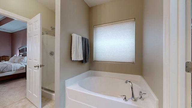 ensuite bathroom featuring a stall shower, ensuite bath, a garden tub, and tile patterned floors