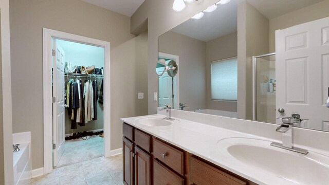 full bath with a shower stall, a garden tub, double vanity, and a sink