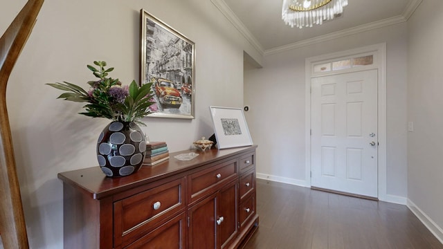 foyer featuring baseboards, dark wood-style flooring, ornamental molding, and a chandelier