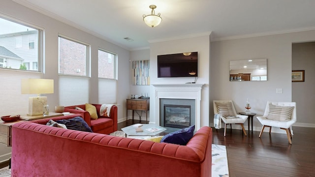 living area featuring crown molding, visible vents, wood finished floors, and baseboards