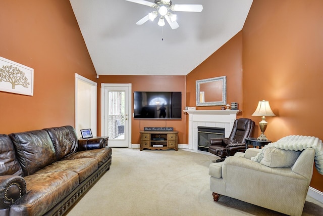 living area featuring high vaulted ceiling, carpet, a ceiling fan, baseboards, and a tile fireplace