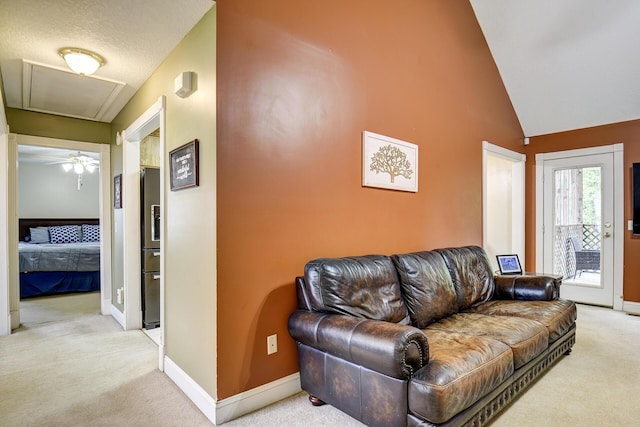 living room featuring baseboards, lofted ceiling, and light colored carpet