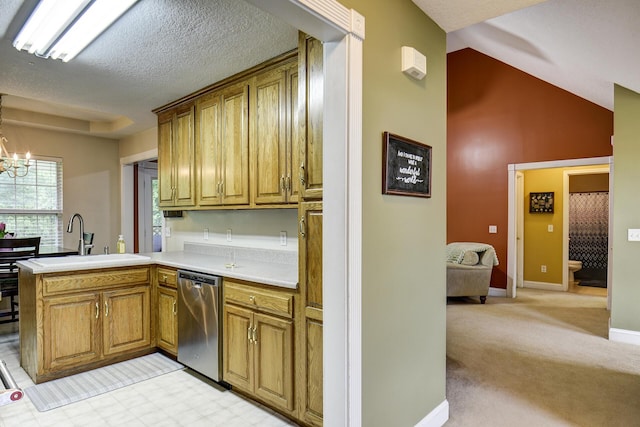 kitchen featuring brown cabinetry, a peninsula, a sink, dishwasher, and a notable chandelier