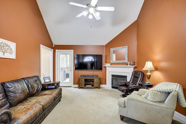 living room with carpet floors, high vaulted ceiling, a ceiling fan, baseboards, and a tile fireplace