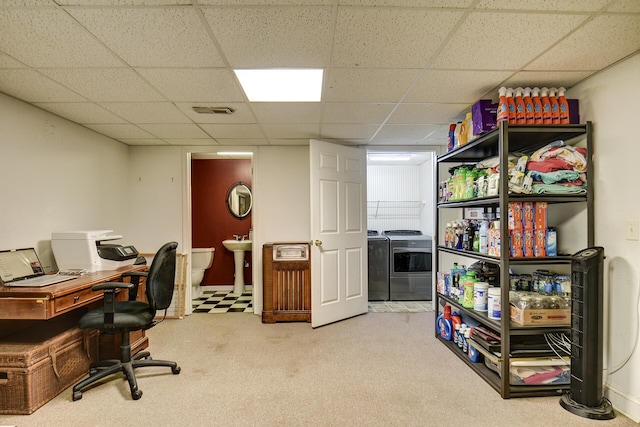 carpeted office space with independent washer and dryer, a sink, visible vents, and a paneled ceiling