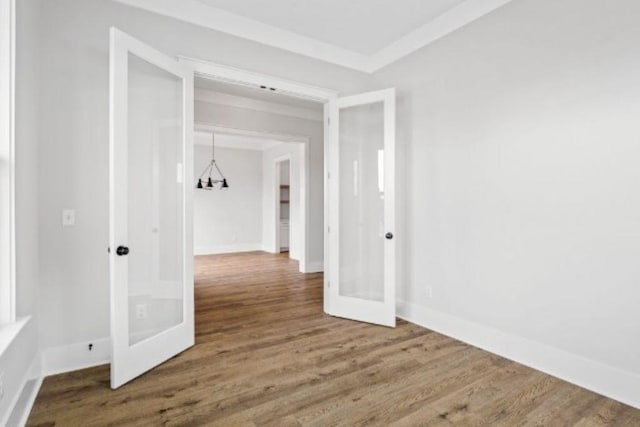 hall featuring baseboards, french doors, and wood finished floors