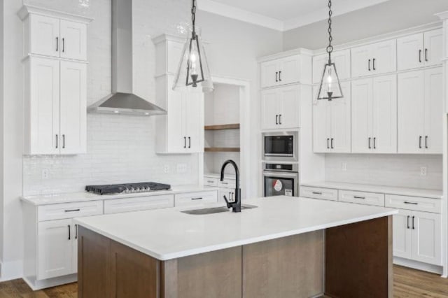 kitchen featuring a sink, cooktop, light countertops, wall chimney exhaust hood, and oven