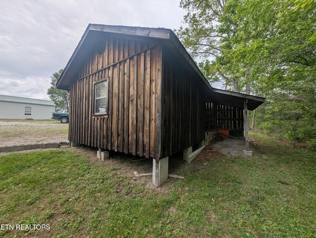 view of side of property featuring board and batten siding and a yard