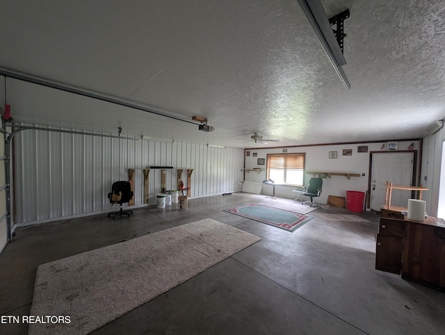 garage with a ceiling fan and a garage door opener