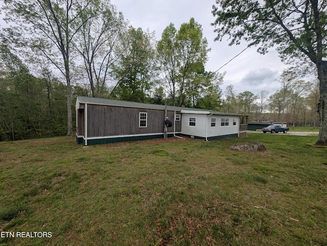 back of property with a lawn