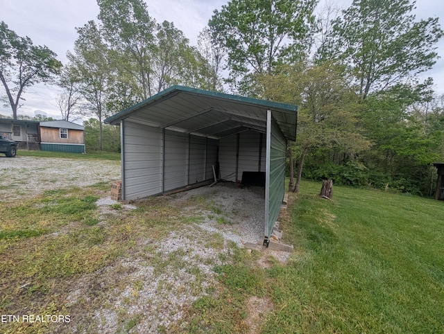 view of outbuilding featuring driveway and a carport